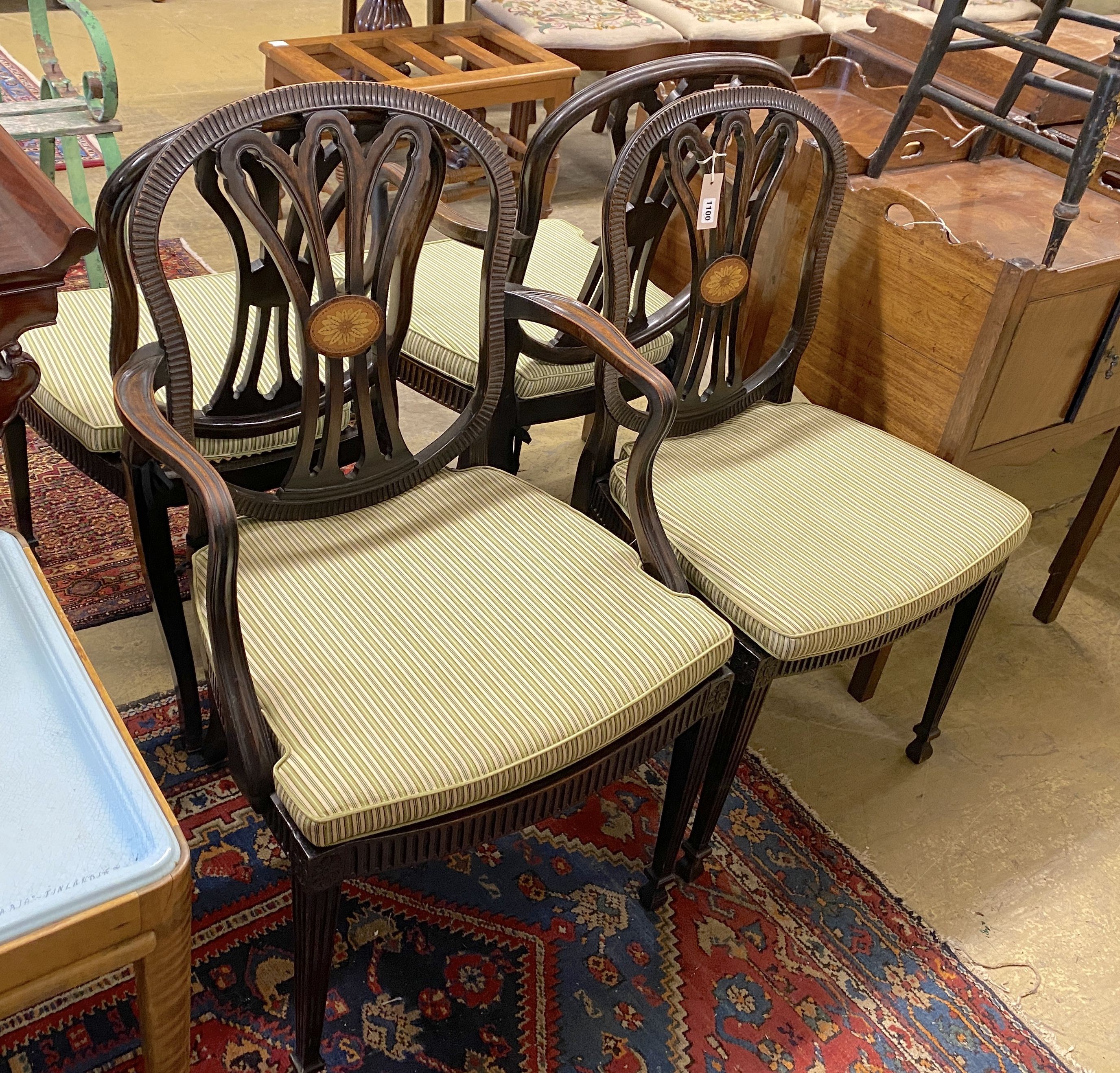 A set of four Edwardian George III style inlaid mahogany dining chairs with arms